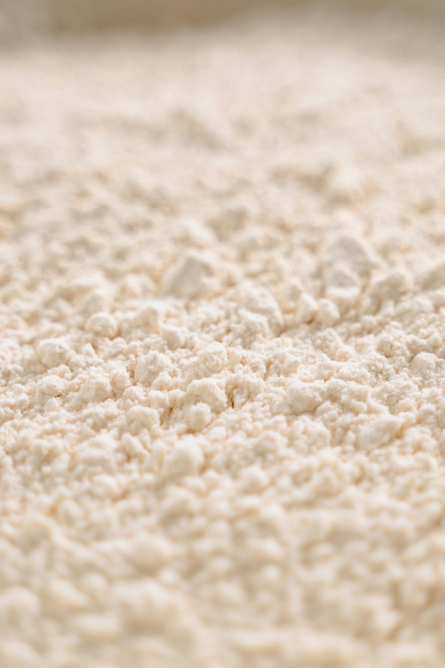 Close-up image of white flour texture, showcasing its fine, powdery consistency.